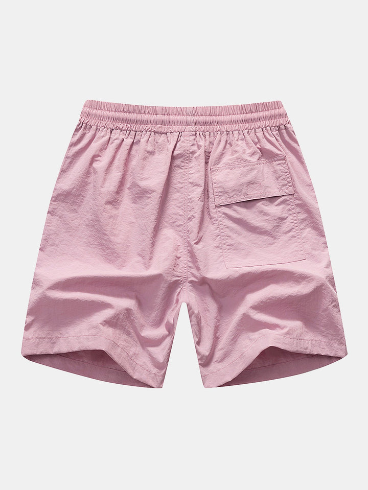 Lightweight polyester beachwear set featuring a vibrant palm tree and flamingo print, includes a stylish shirt and comfortable nylon swim shorts, perfect for summer days 6
