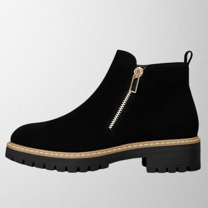 Black ankle boots for women featuring a stylish gold zip, chunky lug sole, and soft suede upper for a comfortable fit. 0