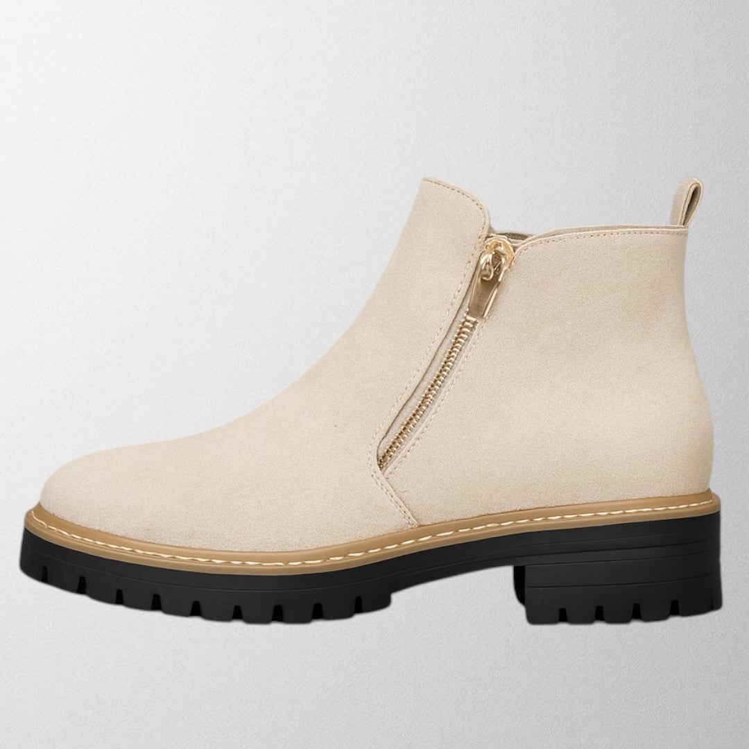 Black ankle boots for women featuring a stylish gold zip, chunky lug sole, and soft suede upper for a comfortable fit. 2