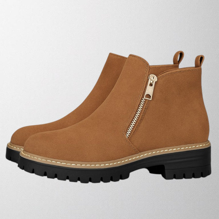 Black ankle boots for women featuring a stylish gold zip, chunky lug sole, and soft suede upper for a comfortable fit. 3