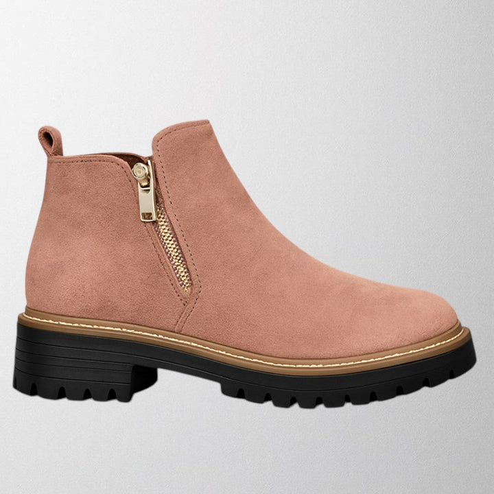 Black ankle boots for women featuring a stylish gold zip, chunky lug sole, and soft suede upper for a comfortable fit. 4