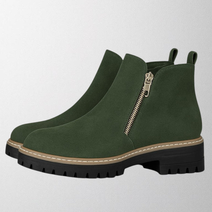 Black ankle boots for women featuring a stylish gold zip, chunky lug sole, and soft suede upper for a comfortable fit. 5