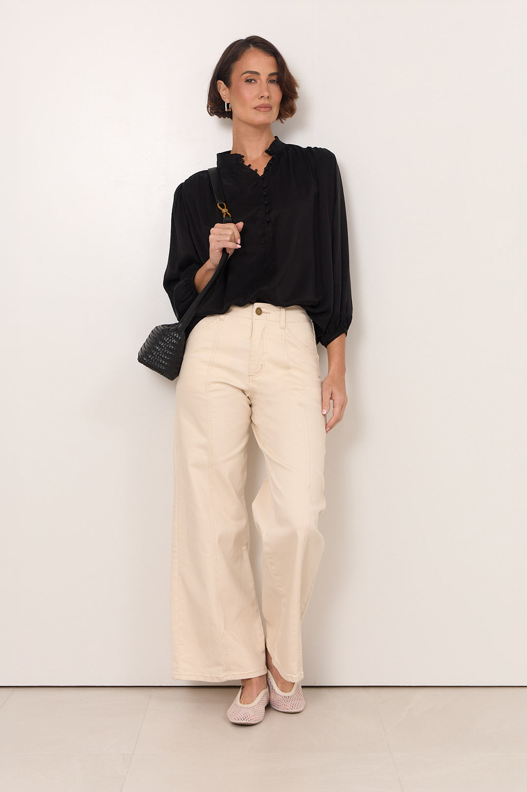 Black Cupro women's top featuring a stylish button-down front and 3/4 sleeves, designed with an elegant fluid drape for a chic and sophisticated 0