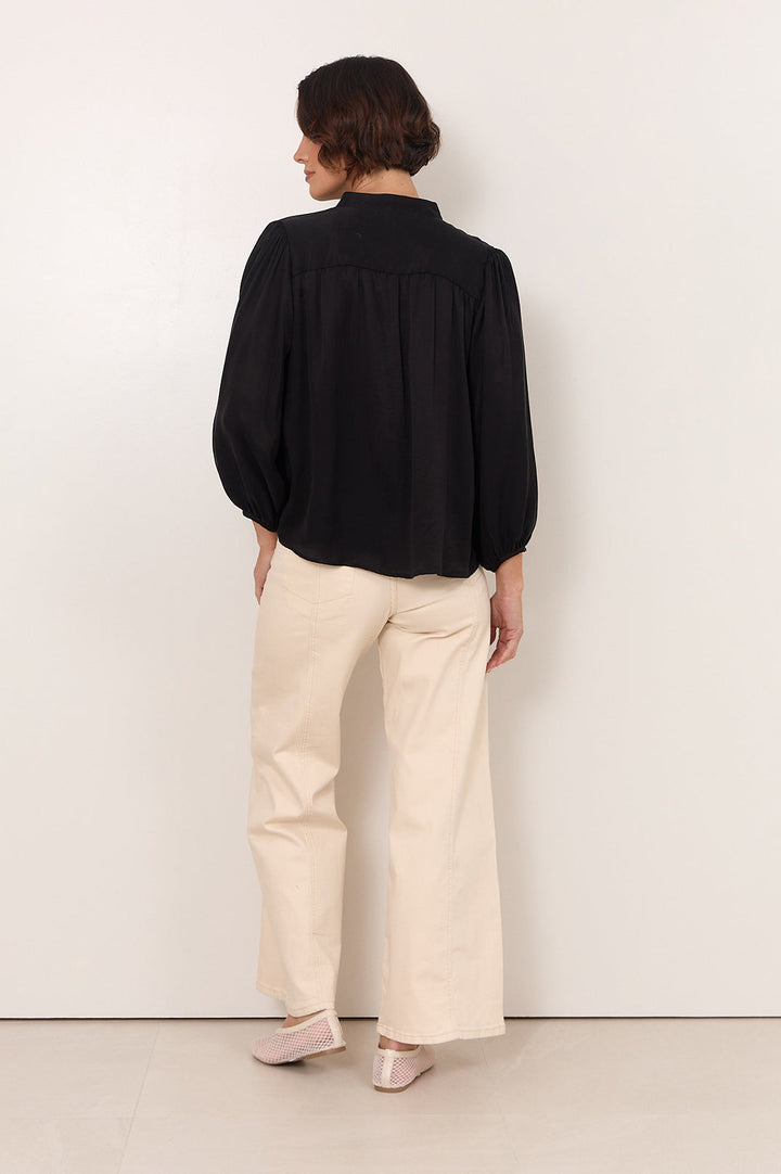 Black Cupro women's top featuring a stylish button-down front and 3/4 sleeves, designed with an elegant fluid drape for a chic and sophisticated 3