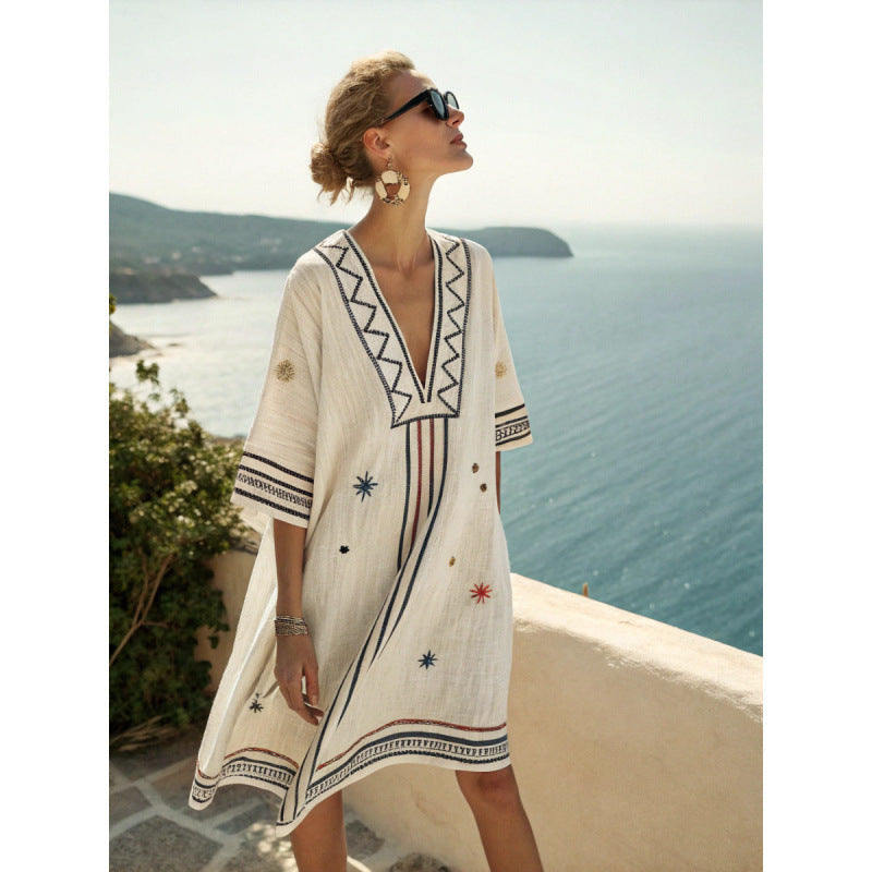 Bohemian kaftan dress featuring intricate embroidery, made from lightweight cotton-linen blend, perfect for summer beach and resort wear. 1