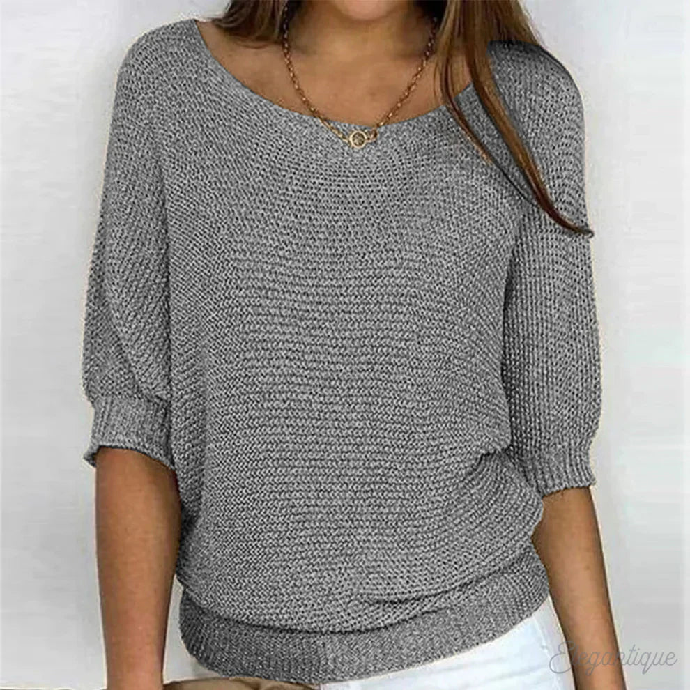 Elegant women's cable knit sweater made from soft knit fabric, featuring a versatile design suitable for all seasons. 1