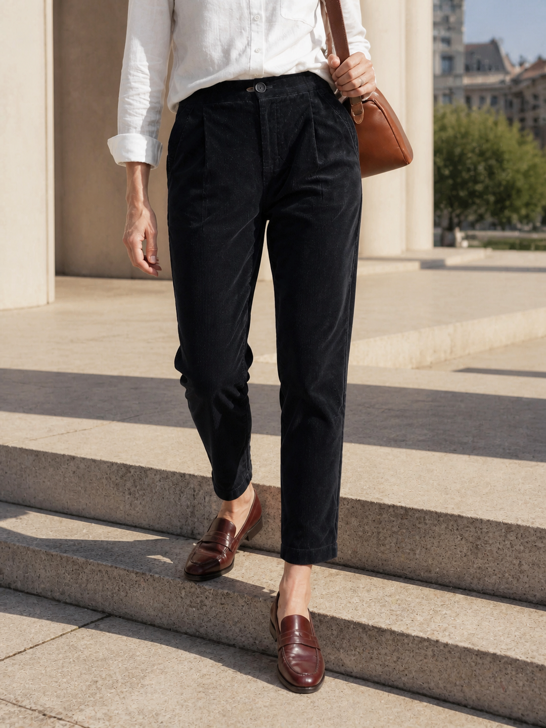 Cotton tapered pants in charcoal black with an elastic waist, designed for a tailored fit for men. 2