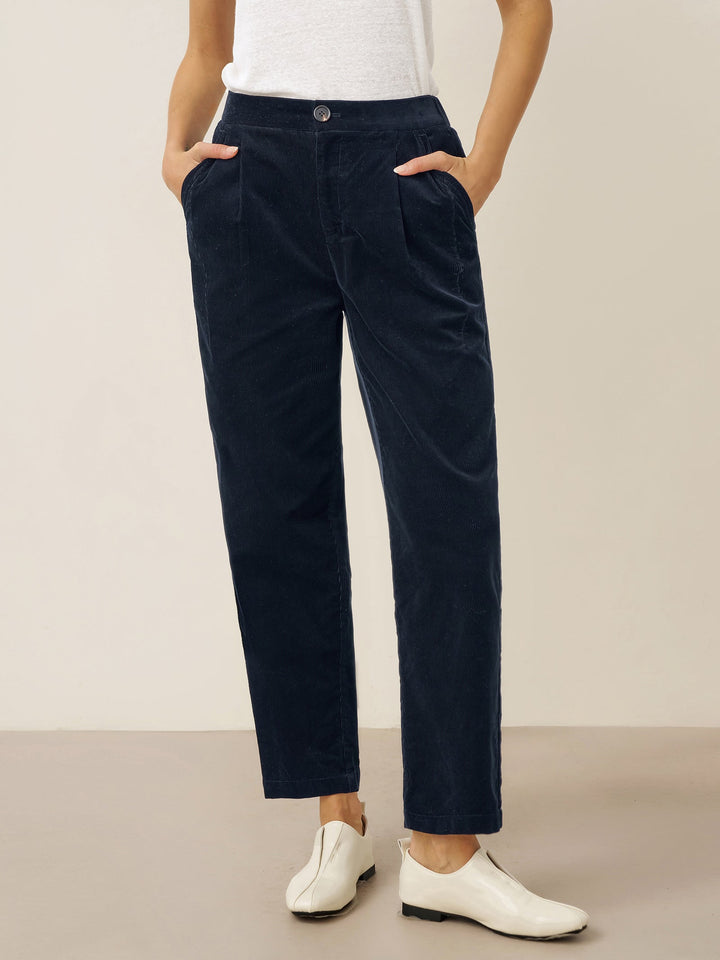 Cotton tapered pants in charcoal black with an elastic waist, designed for a tailored fit for men. 3