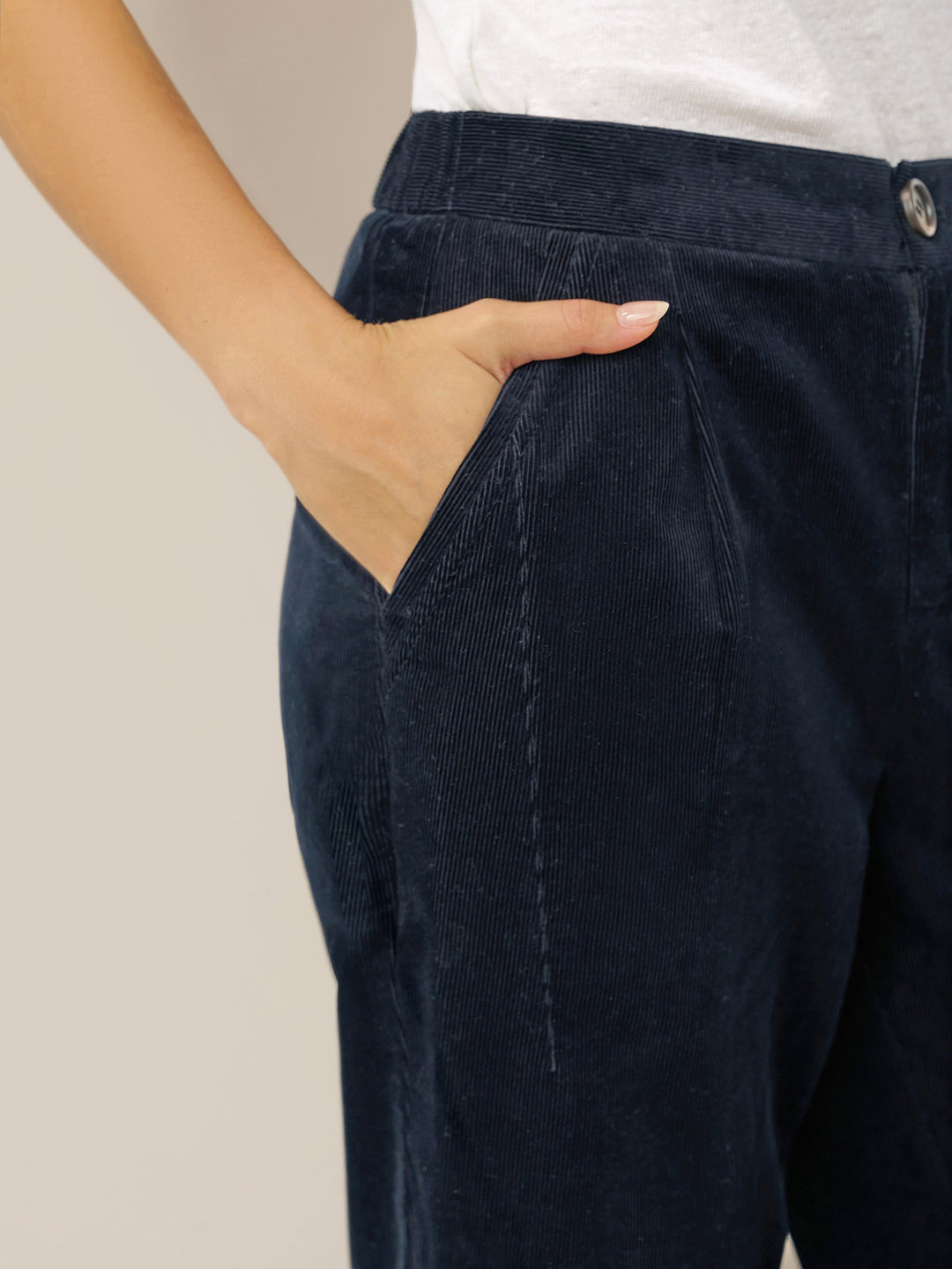 Cotton tapered pants in charcoal black with an elastic waist, designed for a tailored fit for men. 5