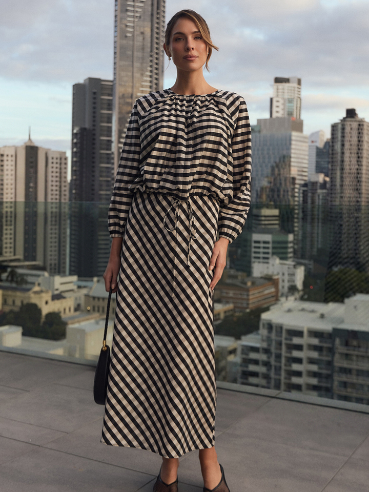 Gingham maxi skirt featuring an adjustable waistband and bias-cut design in black and white, perfect for stylish women's outfits. 0