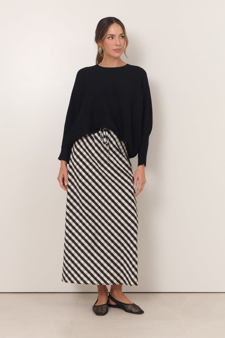 Gingham maxi skirt featuring an adjustable waistband and bias-cut design in black and white, perfect for stylish women's outfits. 2