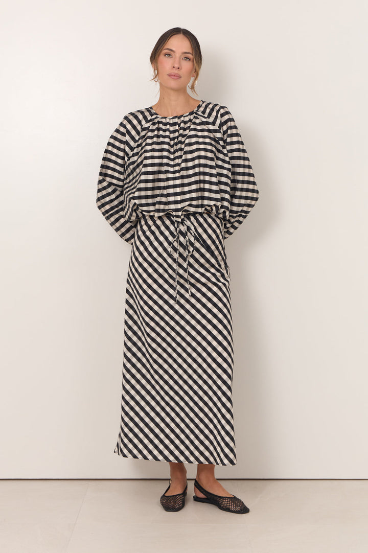Gingham maxi skirt featuring an adjustable waistband and bias-cut design in black and white, perfect for stylish women's outfits. 3
