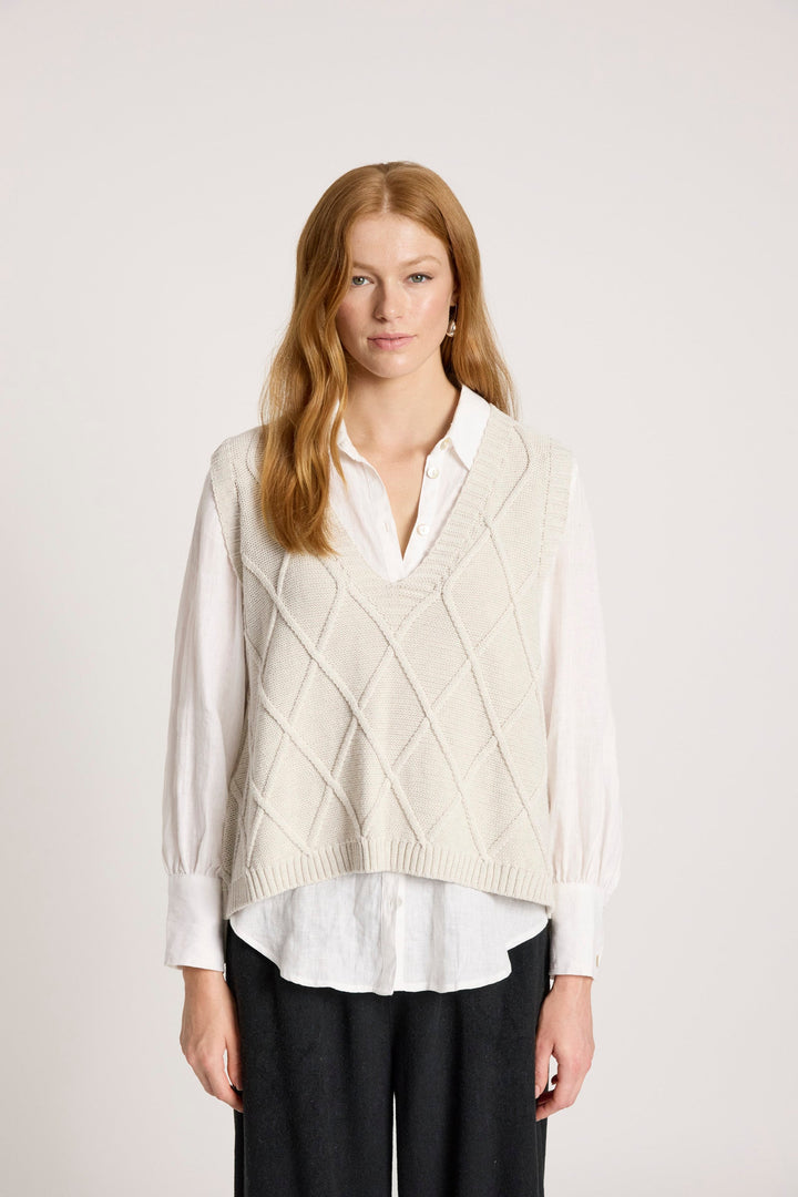 Ladies knitted vest in bisque featuring a stylish V-neck design and a trendy checkerboard pattern, made from breathable cotton for comfort and style. 0