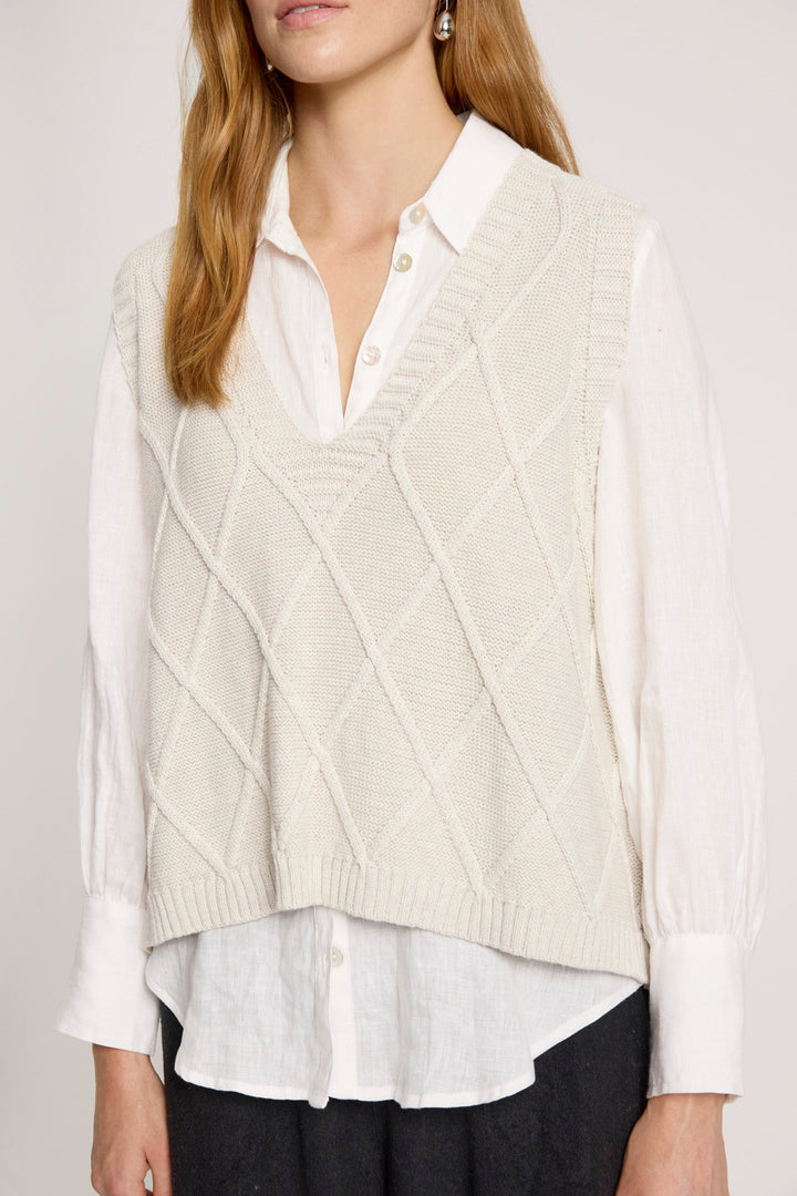 Ladies knitted vest in bisque featuring a stylish V-neck design and a trendy checkerboard pattern, made from breathable cotton for comfort and style. 2