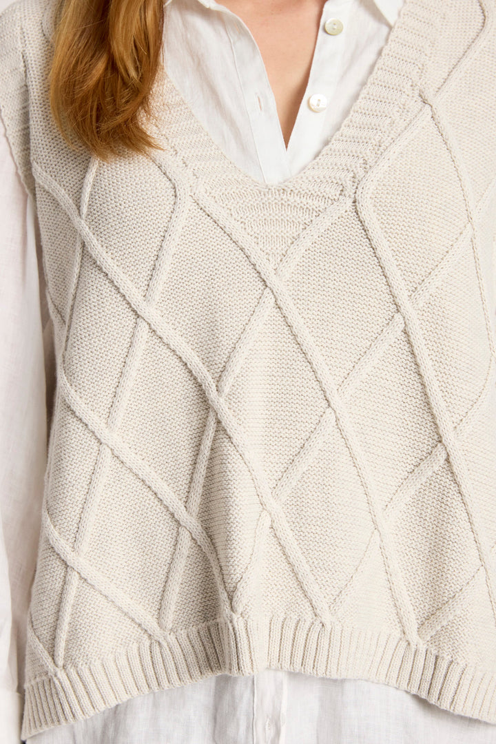 Ladies knitted vest in bisque featuring a stylish V-neck design and a trendy checkerboard pattern, made from breathable cotton for comfort and style. 3