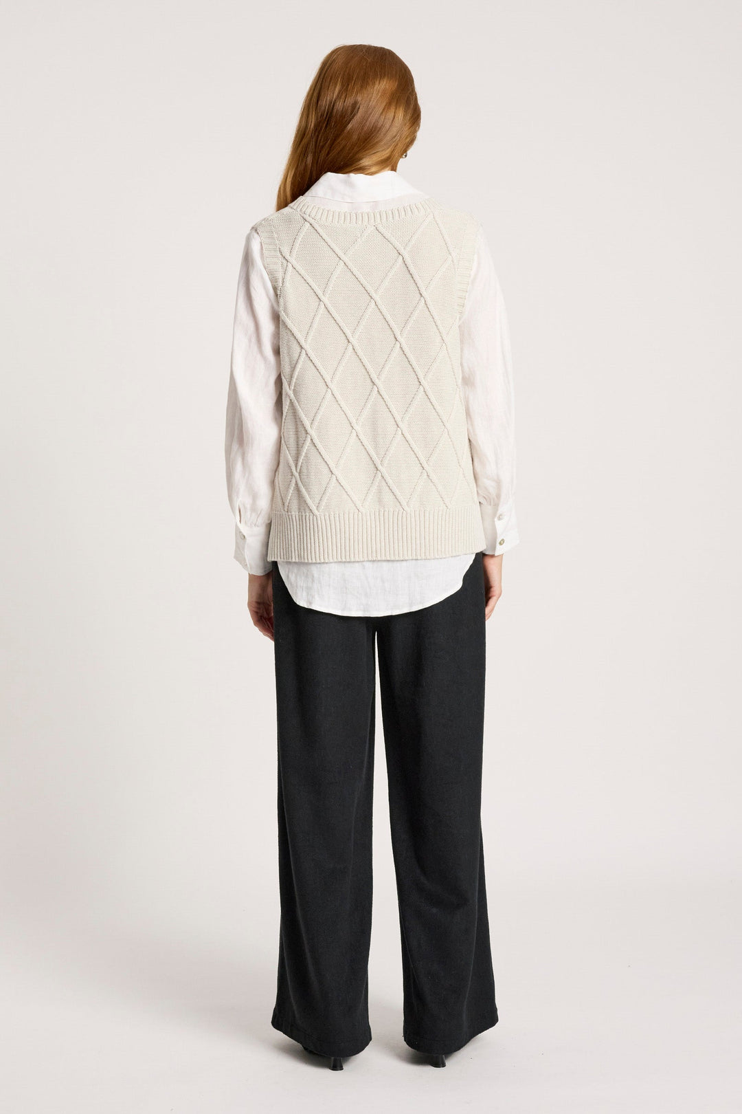 Ladies knitted vest in bisque featuring a stylish V-neck design and a trendy checkerboard pattern, made from breathable cotton for comfort and style. 6