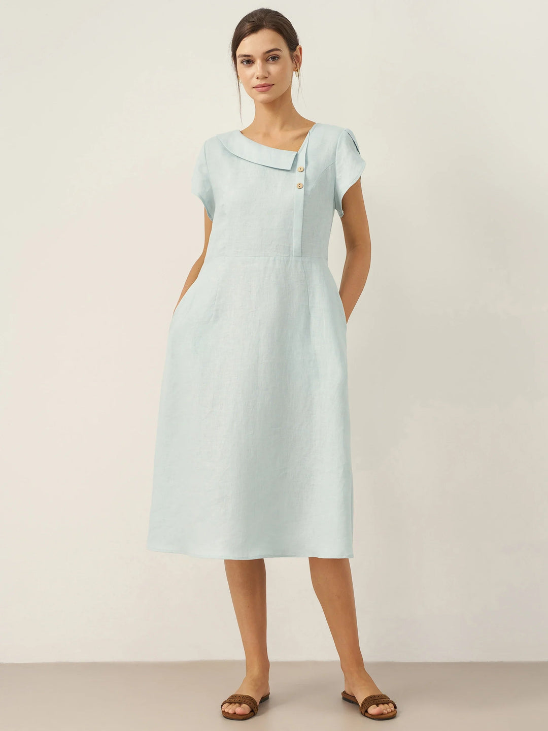Linen midi dress featuring asymmetric button detail and cap sleeves, designed for a tailored fit, perfect for wedding guests and summer events. 0