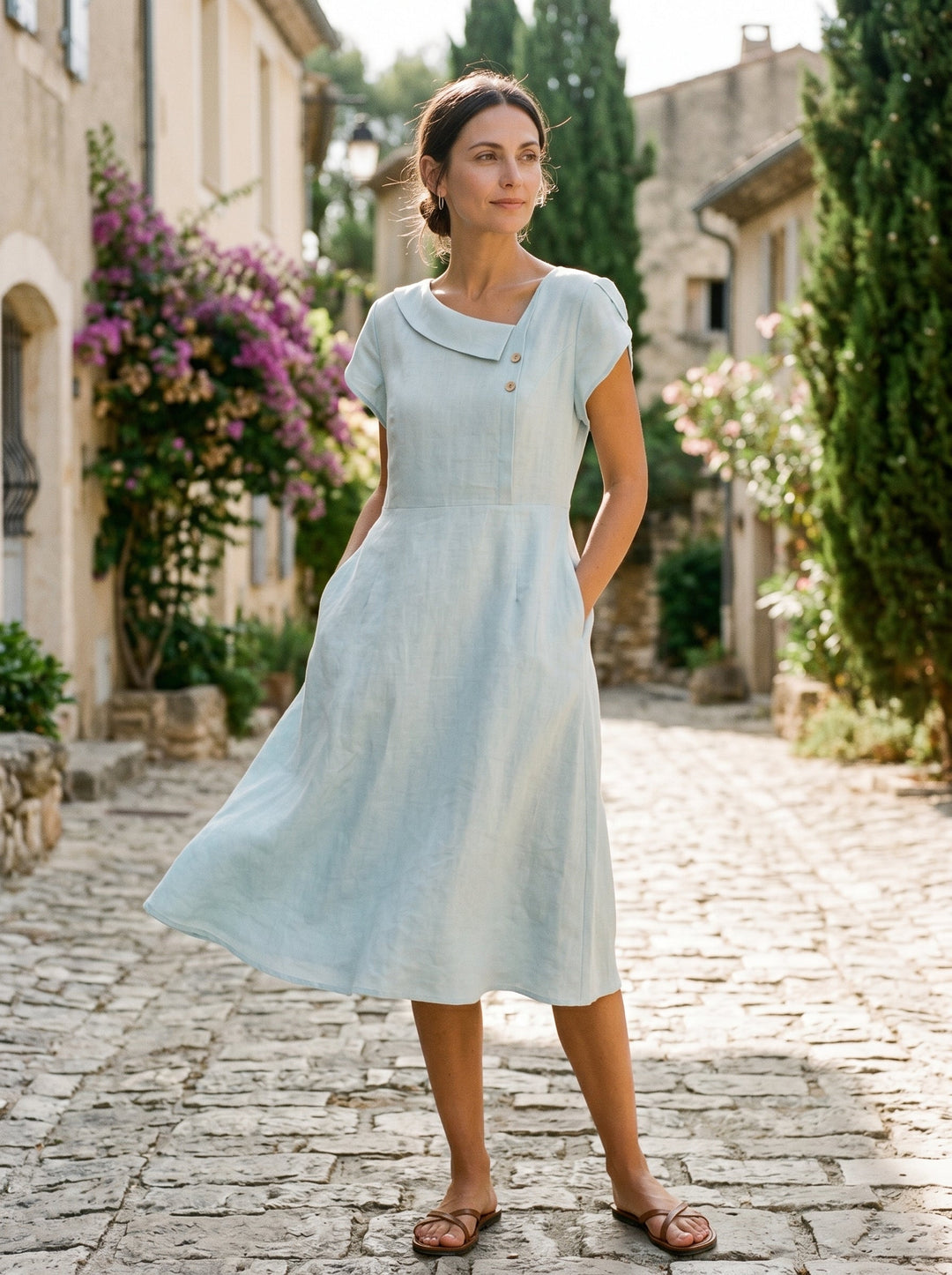 Linen midi dress featuring asymmetric button detail and cap sleeves, designed for a tailored fit, perfect for wedding guests and summer events. 1