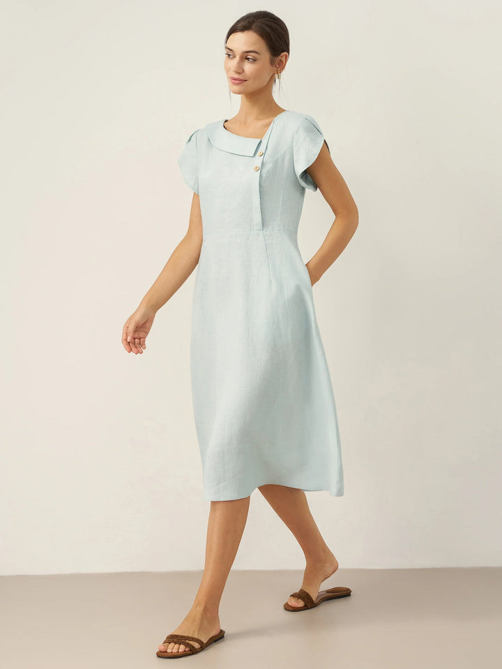 Linen midi dress featuring asymmetric button detail and cap sleeves, designed for a tailored fit, perfect for wedding guests and summer events. 3
