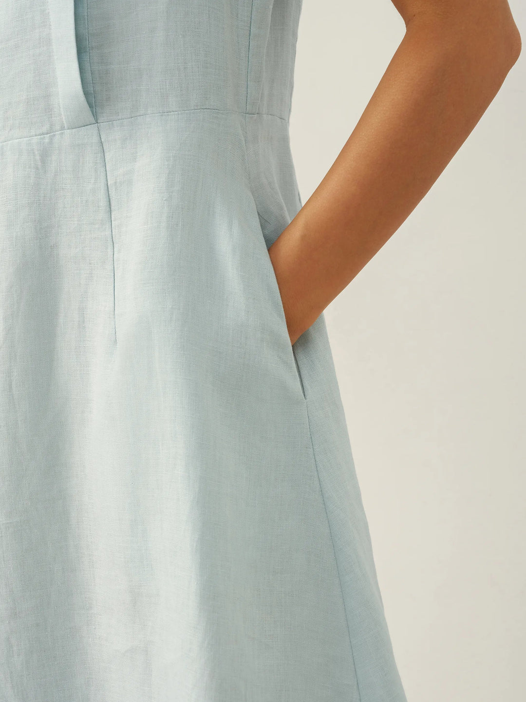 Linen midi dress featuring asymmetric button detail and cap sleeves, designed for a tailored fit, perfect for wedding guests and summer events. 5
