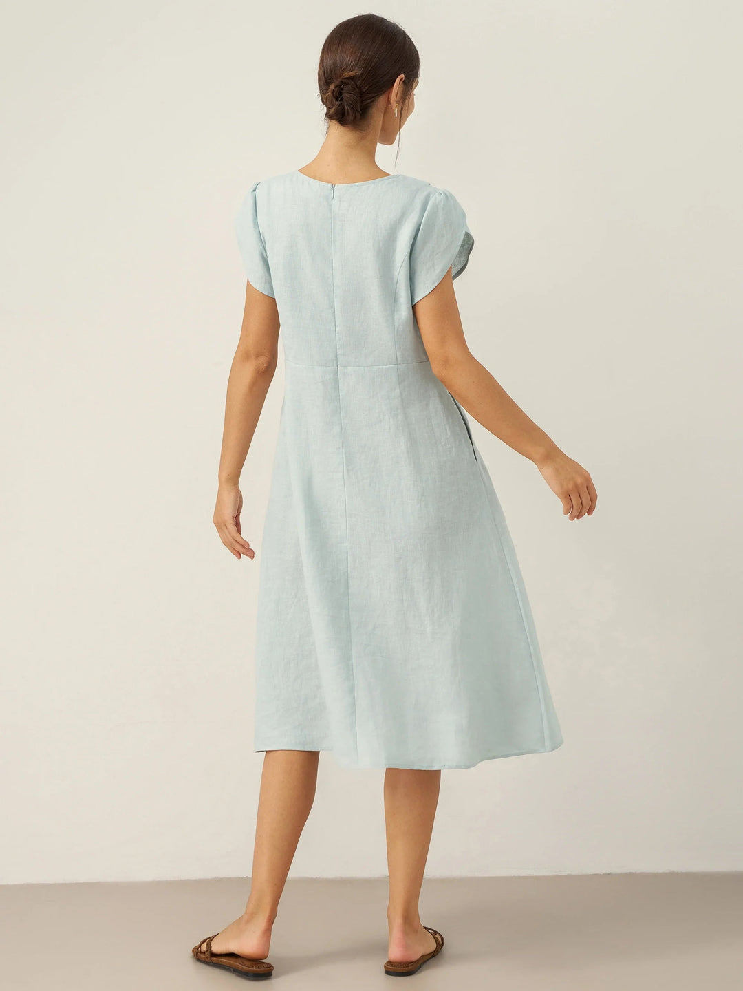 Linen midi dress featuring asymmetric button detail and cap sleeves, designed for a tailored fit, perfect for wedding guests and summer events. 6