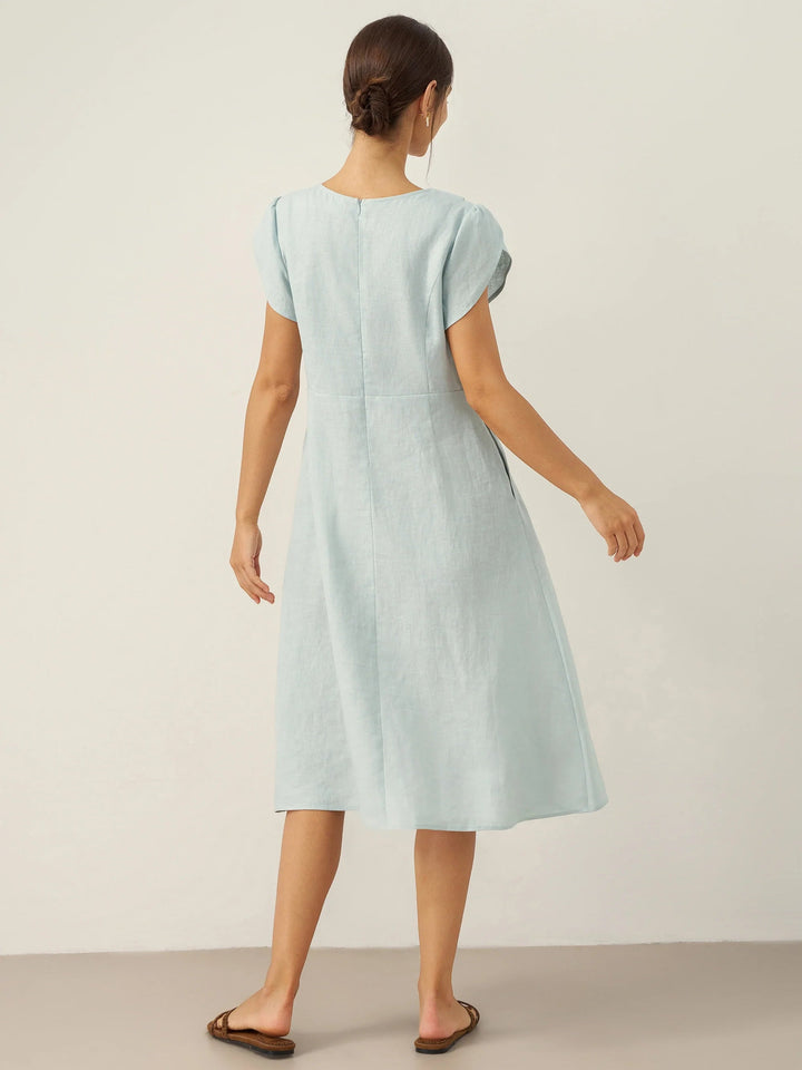 Linen midi dress featuring asymmetric button detail and cap sleeves, designed for a tailored fit, perfect for wedding guests and summer events. 6