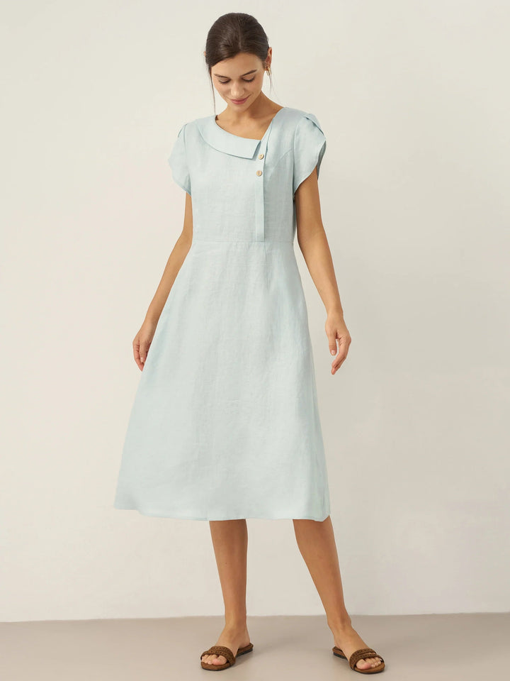 Linen midi dress featuring asymmetric button detail and cap sleeves, designed for a tailored fit, perfect for wedding guests and summer events. 7