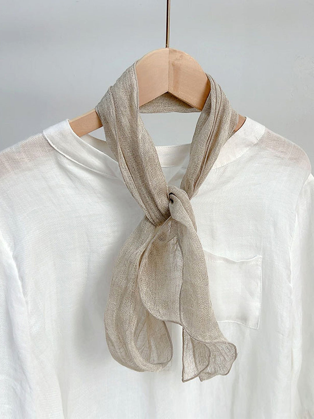 Linen scarf featuring a hand tie-dye finish in various colors, showcasing a soft and lightweight design perfect for year-round wear. 0