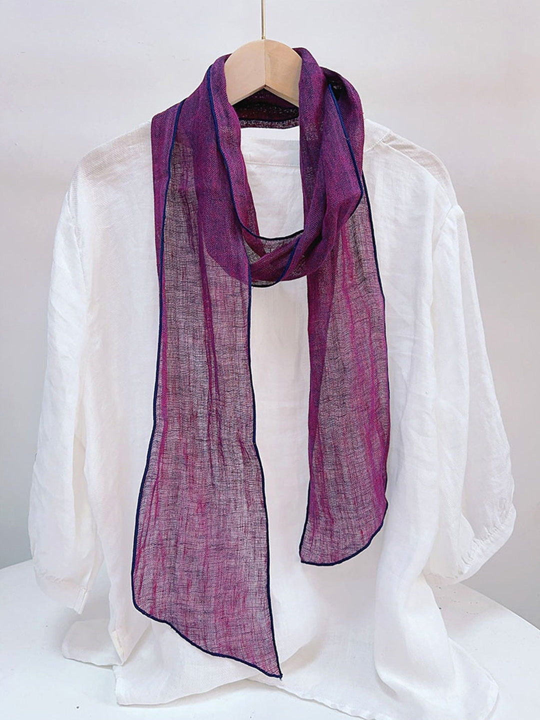 Linen scarf featuring a hand tie-dye finish in various colors, showcasing a soft and lightweight design perfect for year-round wear. 3