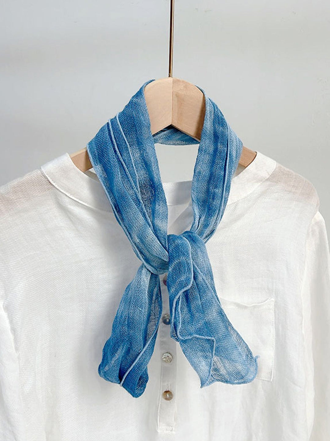 Linen scarf featuring a hand tie-dye finish in various colors, showcasing a soft and lightweight design perfect for year-round wear. 6