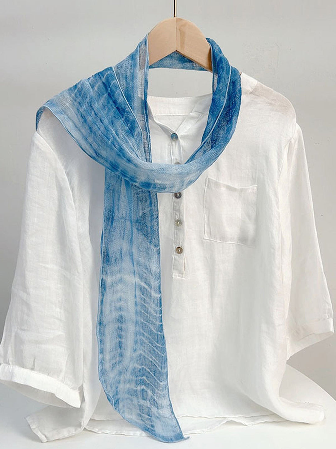 Linen scarf featuring a hand tie-dye finish in various colors, showcasing a soft and lightweight design perfect for year-round wear. 7