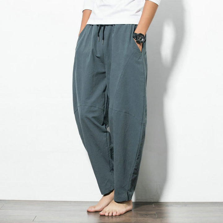 Men's casual tapered fit cotton joggers with drawstring and pockets, available in solid colors, perfect for everyday wear. 1