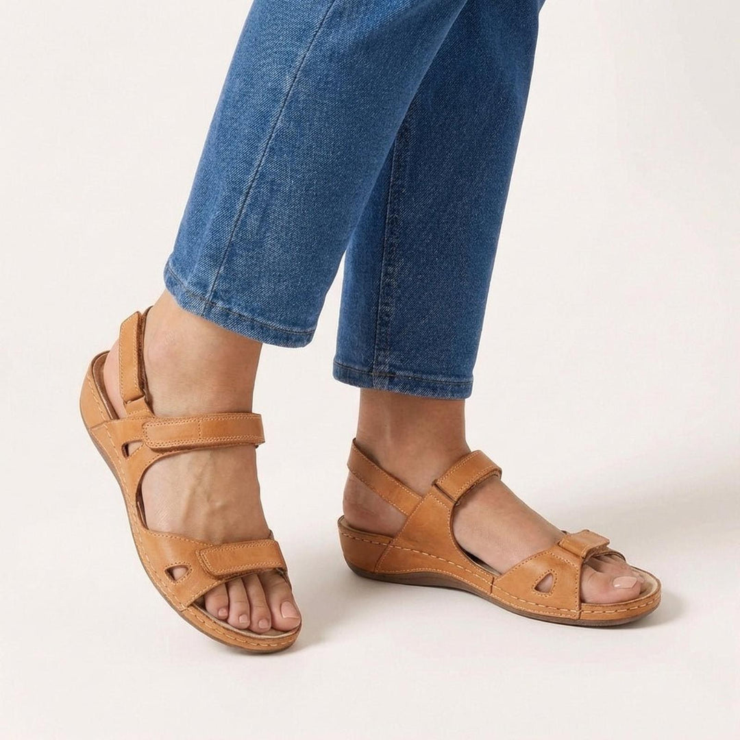 Orthopedic women's sandals featuring an adjustable strap and open-toe design, designed for comfort and support for all-day wear. 1