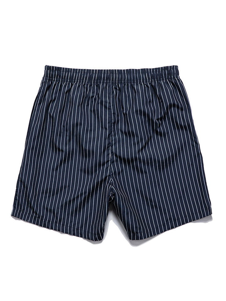 Palm tree print shirt paired with striped swim shorts set, made from 100% polyester, designed for a regular fit, perfect for summer beachwear. 4