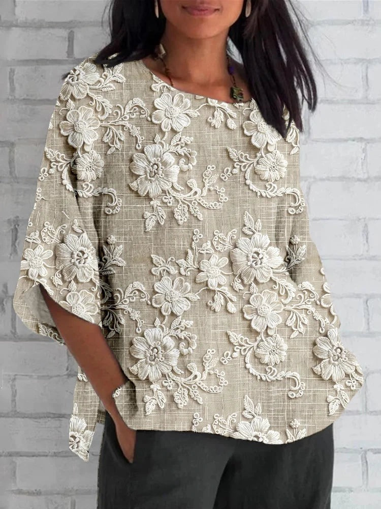 Plus size 3/4 sleeve top featuring floral embroidery and a relaxed fit, perfect for comfortable casual wear. 0
