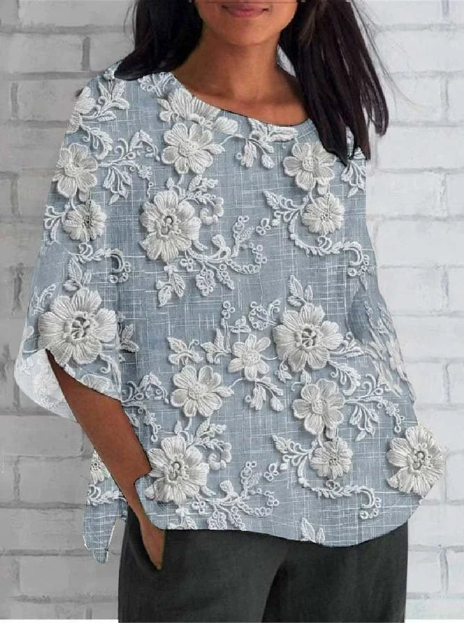 Plus size 3/4 sleeve top featuring floral embroidery and a relaxed fit, perfect for comfortable casual wear. 1