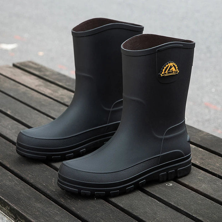 Men's waterproof rain boots featuring a slip-resistant sole, designed with a mid-calf height for optimal protection and comfort in wet conditions. 0