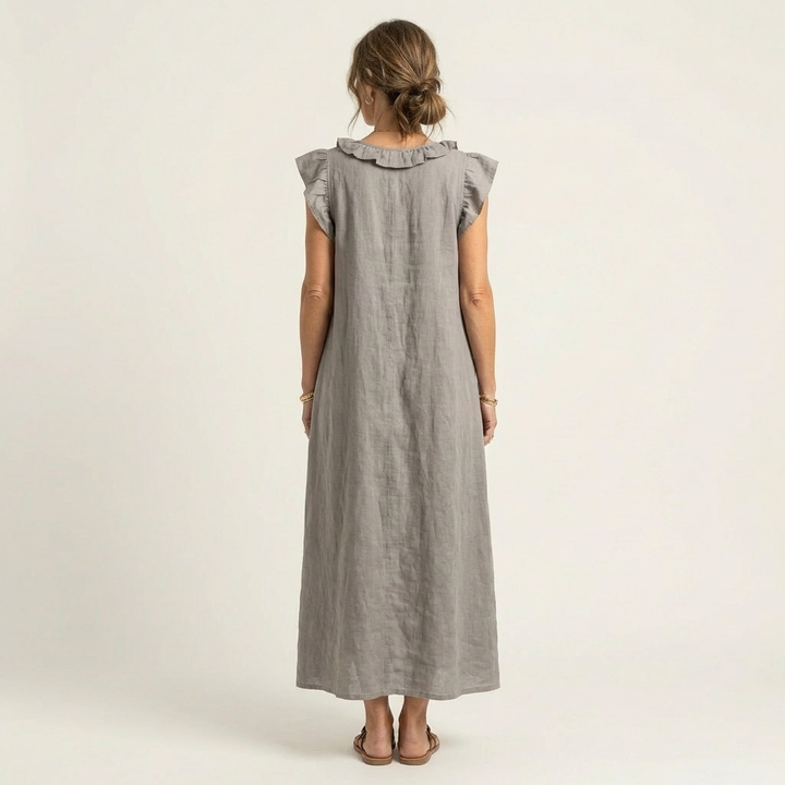 Ruffle V-Neck Maxi Dress in white made from a cotton linen blend, featuring side pockets and a relaxed fit, perfect for casual summer outings. 1