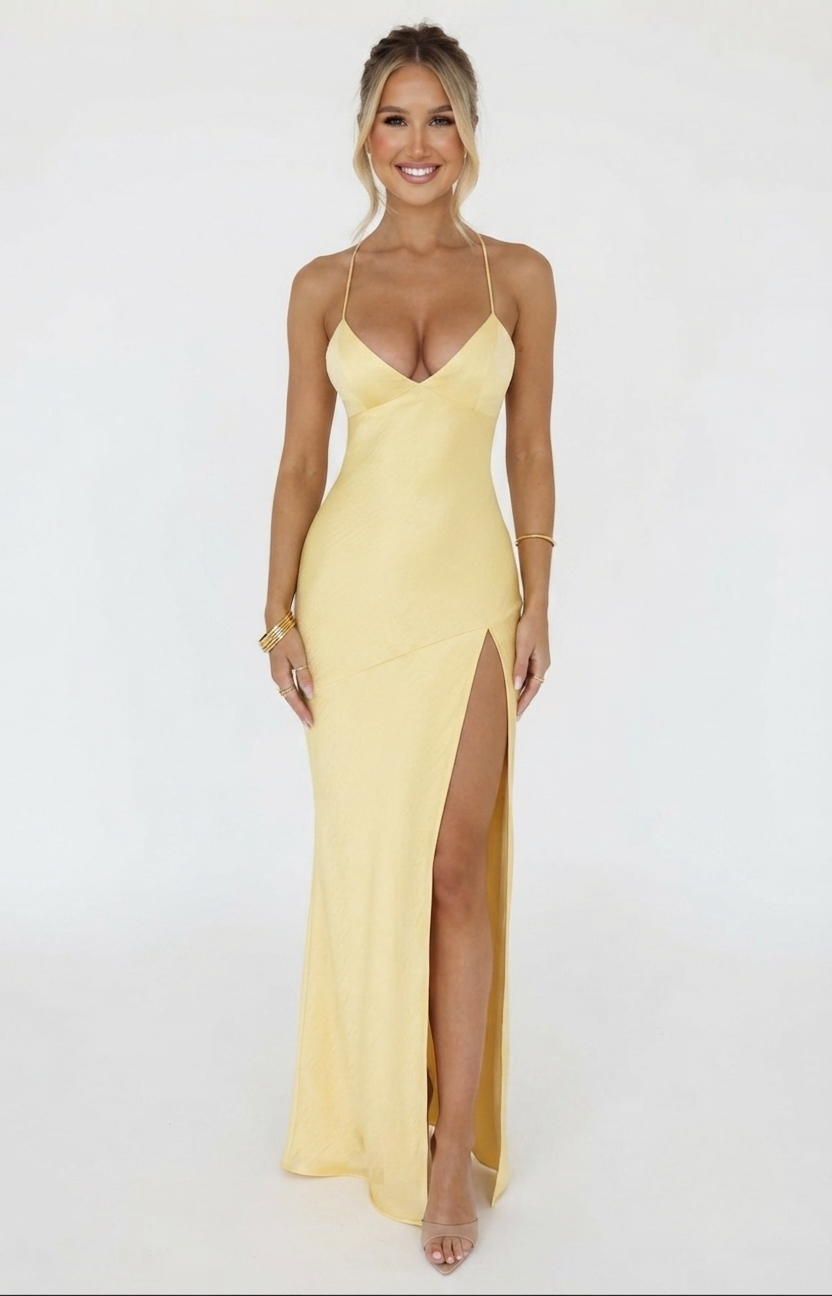 Satin halter neck maxi dress in butter yellow featuring a thigh-high slit, perfect for elegant evening events and summer occasions. 0