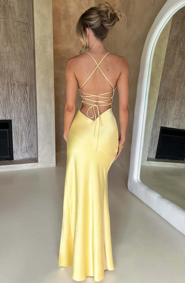 Satin halter neck maxi dress in butter yellow featuring a thigh-high slit, perfect for elegant evening events and summer occasions. 3
