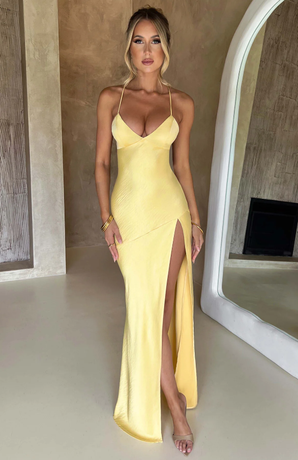 Satin halter neck maxi dress in butter yellow featuring a thigh-high slit, perfect for elegant evening events and summer occasions. 4