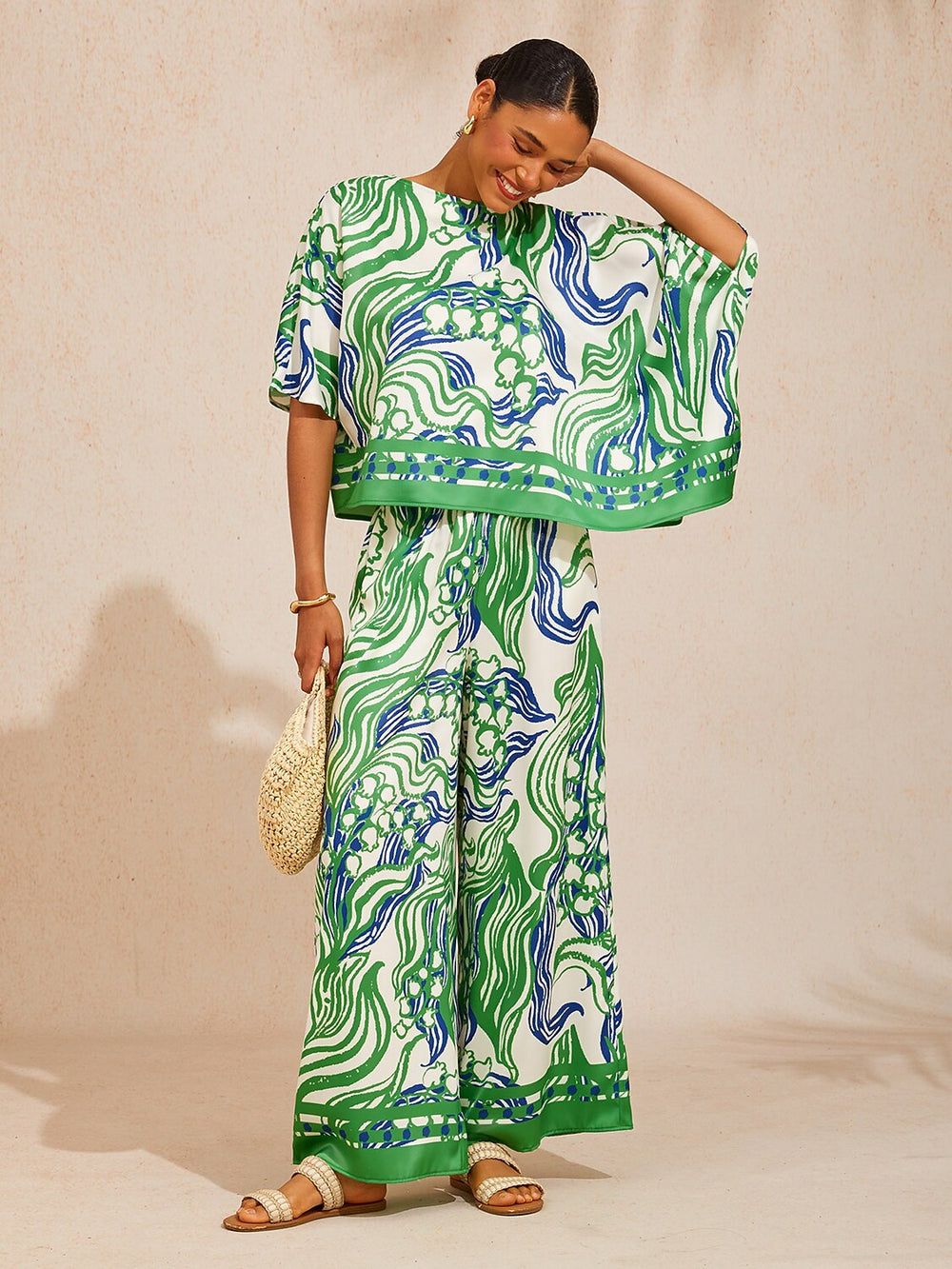 Satin wide leg pants featuring a floral motif and elastic waistband, designed for a flowy relaxed fit, perfect for women's casual and chic outfits. 1