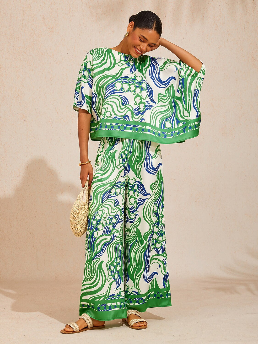 Satin wide leg pants featuring a floral motif and elastic waistband, designed for a flowy relaxed fit, perfect for women's casual and chic outfits. 1