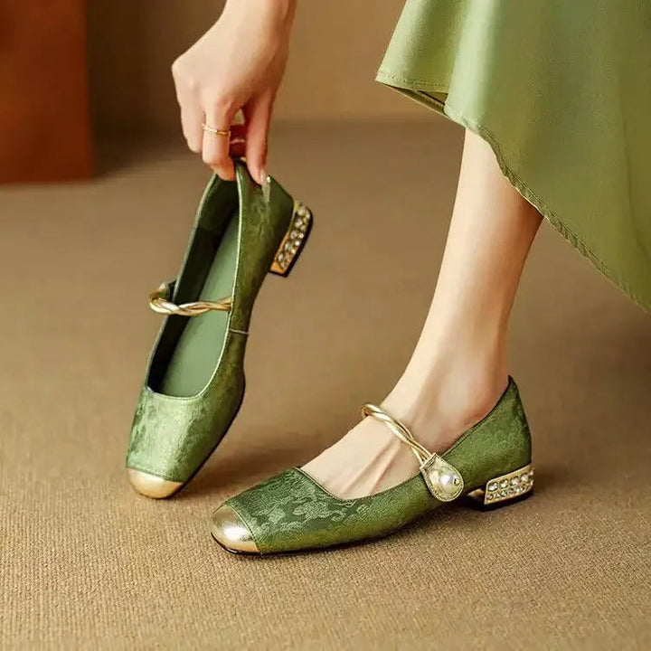 Elegant silk-like evening pumps featuring a pearl strap and embellished square heel, perfect for formal occasions. 0