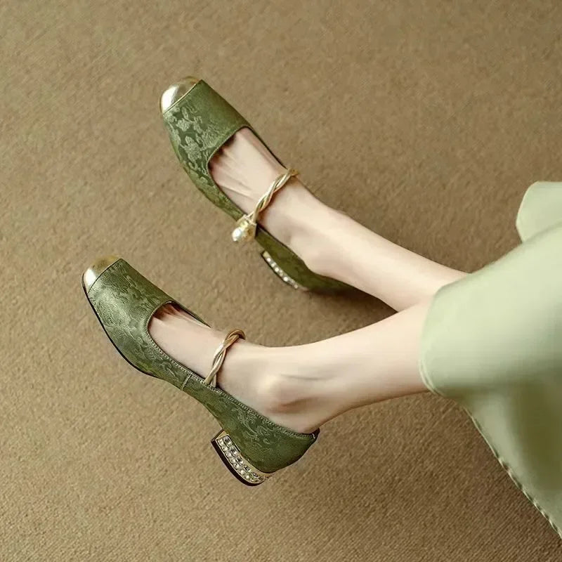 Elegant silk-like evening pumps featuring a pearl strap and embellished square heel, perfect for formal occasions. 1