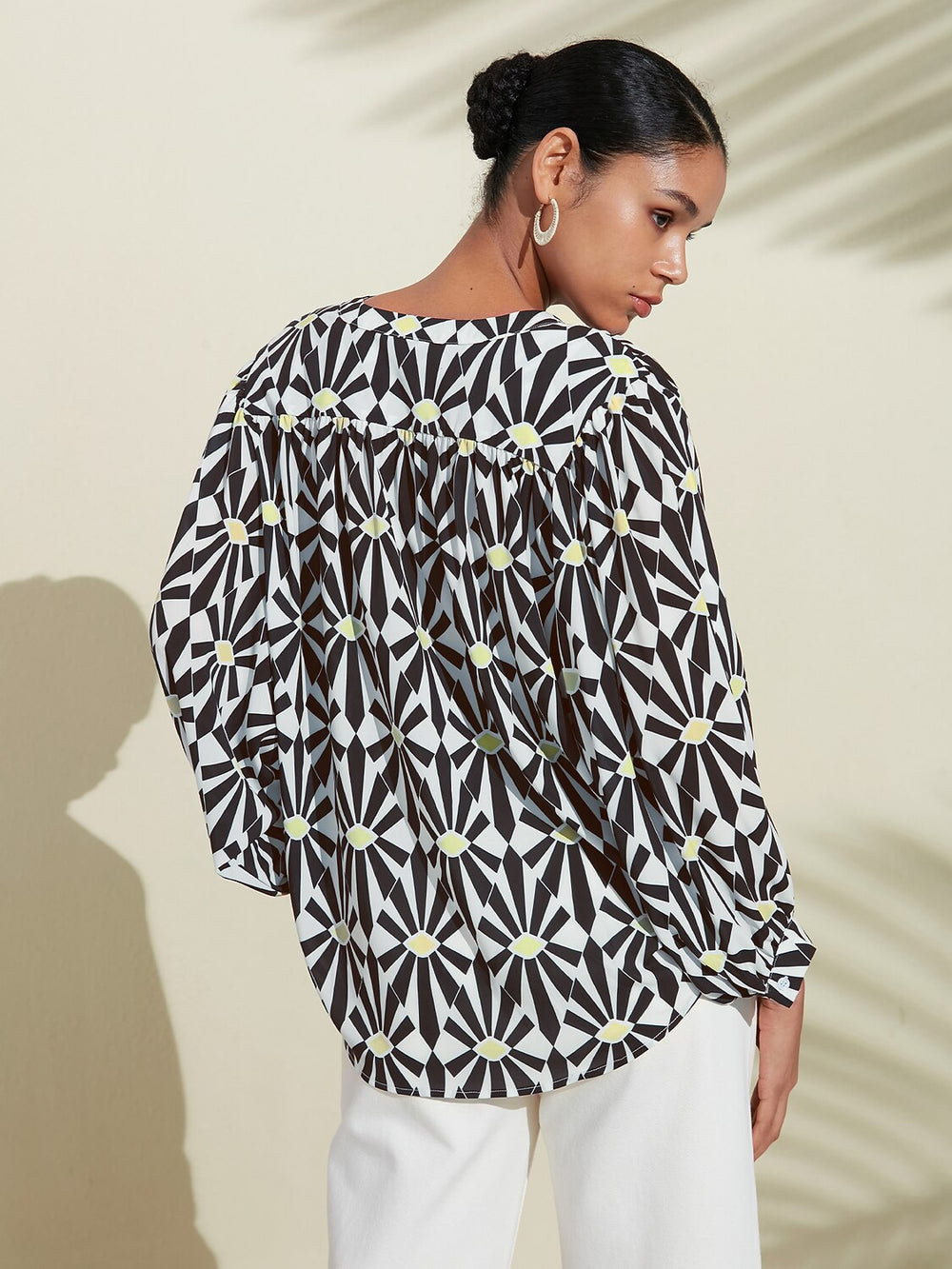 Silky satin blouse featuring a vibrant Moroccan floral print, designed with a relaxed fit, button-down front, and long sleeves for a stylish and comfortable look 1