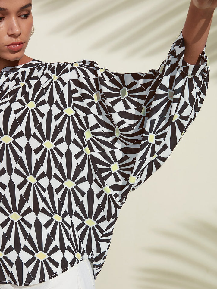 Silky satin blouse featuring a vibrant Moroccan floral print, designed with a relaxed fit, button-down front, and long sleeves for a stylish and comfortable look 2