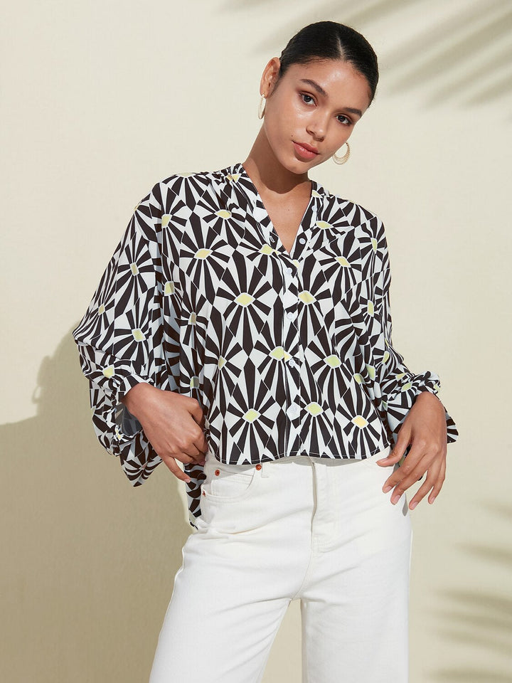 Silky satin blouse featuring a vibrant Moroccan floral print, designed with a relaxed fit, button-down front, and long sleeves for a stylish and comfortable look 3