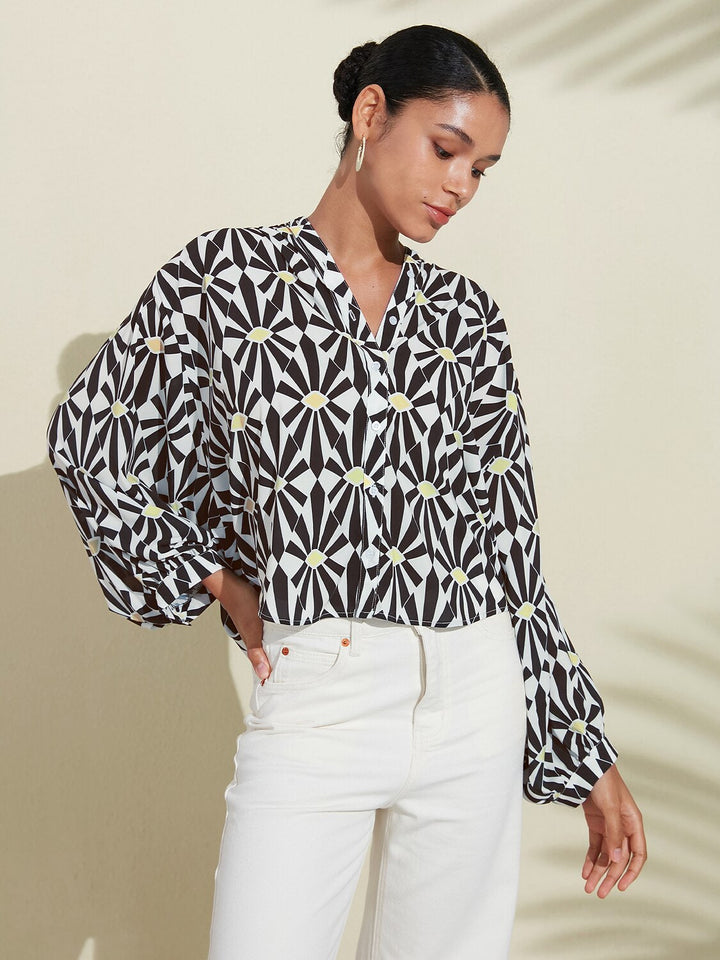 Silky satin blouse featuring a vibrant Moroccan floral print, designed with a relaxed fit, button-down front, and long sleeves for a stylish and comfortable look 6