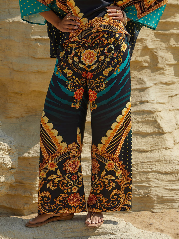 Silky satin women's pants in Mediterranean blue featuring a gold-chain print and an elastic waistband, designed in a stylish straight-leg cut. 10